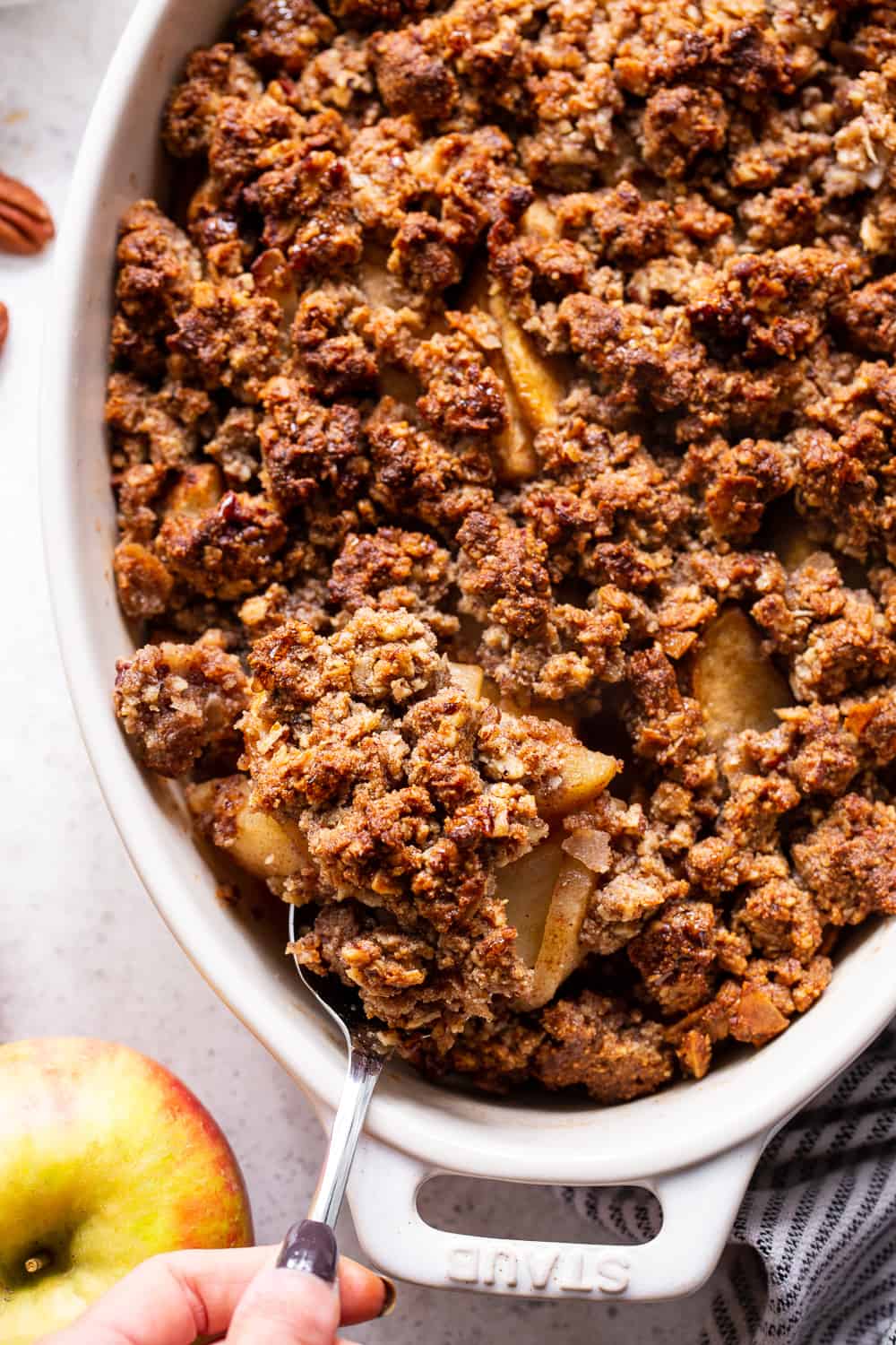 A healthy version of a classic fall dessert, this Paleo Maple Pecan Apple Crisp is the perfect warm and sweet comfort food on cozy nights.  It's grain free, gluten free, paleo, vegan, and soy free with simple whole ingredients and the fall flavors you crave. #paleo #vegan #cleaneating #applecrisp #healthybaking