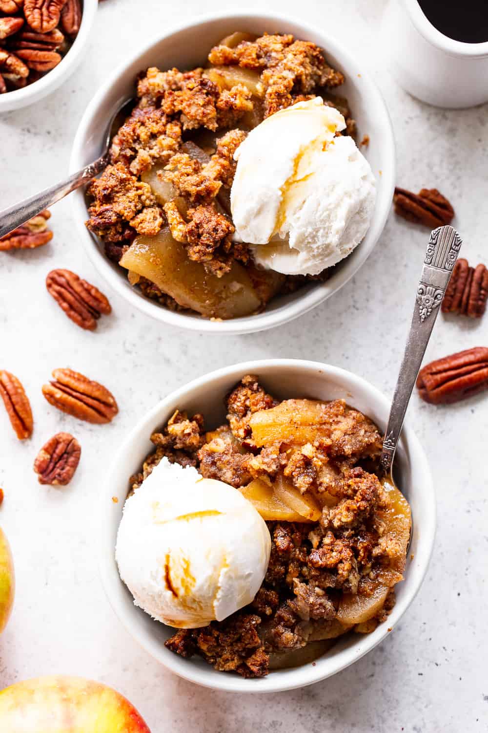 A healthy version of a classic fall dessert, this Paleo Maple Pecan Apple Crisp is the perfect warm and sweet comfort food on cozy nights.  It's grain free, gluten free, paleo, vegan, and soy free with simple whole ingredients and the fall flavors you crave. #paleo #vegan #cleaneating #applecrisp #healthybaking