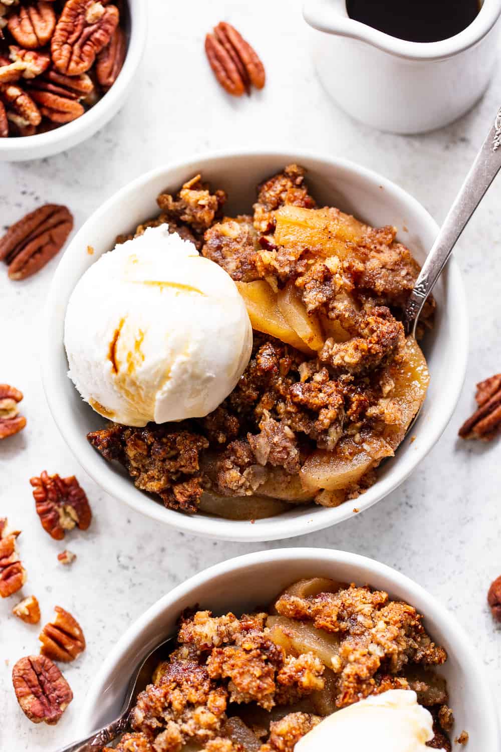 A healthy version of a classic fall dessert, this Paleo Maple Pecan Apple Crisp is the perfect warm and sweet comfort food on cozy nights.  It's grain free, gluten free, paleo, vegan, and soy free with simple whole ingredients and the fall flavors you crave. #paleo #vegan #cleaneating #applecrisp #healthybaking