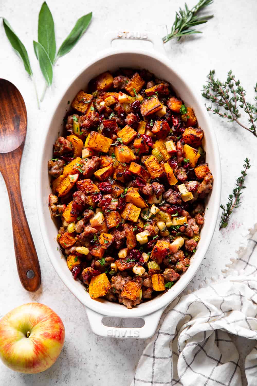 This delicious Butternut Sausage Paleo Stuffing with apples and cranberries has all the flavor of traditional Thanksgiving stuffing or dressing but is grain free, gluten free, dairy free and Whole30 friendly too! Toasty, sweet roasted butternut squash and savory sausage form the base for this Paleo style holiday favorite. #paleo #thanksgiving #sidedish #butternutsquash #cleaneating #grainfree #whole30