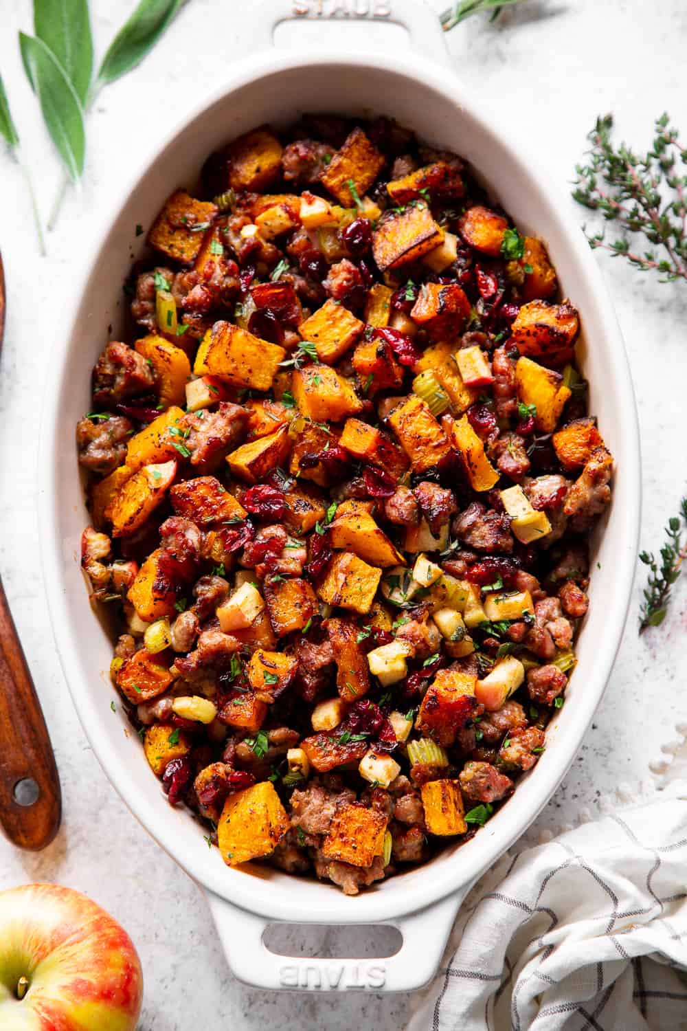 This delicious Butternut Sausage Paleo Stuffing with apples and cranberries has all the flavor of traditional Thanksgiving stuffing or dressing but is grain free, gluten free, dairy free and Whole30 friendly too! Toasty, sweet roasted butternut squash and savory sausage form the base for this Paleo style holiday favorite. #paleo #thanksgiving #sidedish #butternutsquash #cleaneating #grainfree #whole30