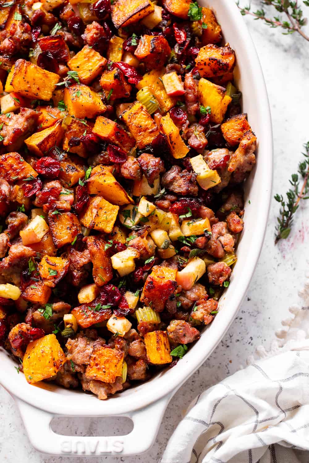 This delicious Butternut Sausage Paleo Stuffing with apples and cranberries has all the flavor of traditional Thanksgiving stuffing or dressing but is grain free, gluten free, dairy free and Whole30 friendly too! Toasty, sweet roasted butternut squash and savory sausage form the base for this Paleo style holiday favorite. #paleo #thanksgiving #sidedish #butternutsquash #cleaneating #grainfree #whole30