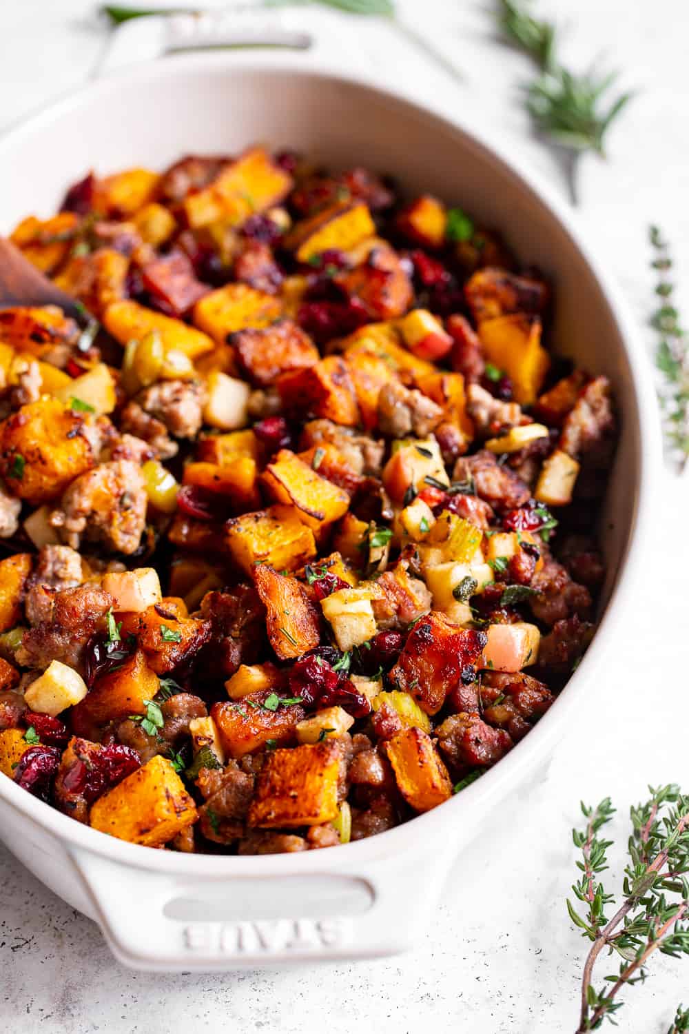 This delicious Butternut Sausage Paleo Stuffing with apples and cranberries has all the flavor of traditional Thanksgiving stuffing or dressing but is grain free, gluten free, dairy free and Whole30 friendly too! Toasty, sweet roasted butternut squash and savory sausage form the base for this Paleo style holiday favorite. #paleo #thanksgiving #sidedish #butternutsquash #cleaneating #grainfree #whole30