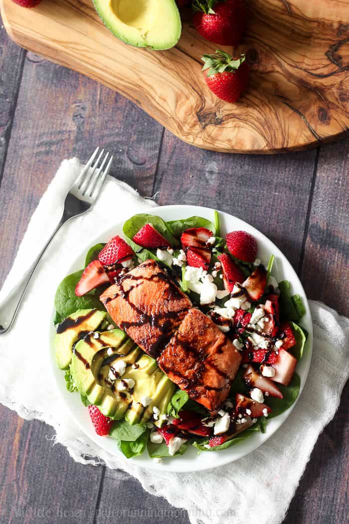 salmon avocado strawberry salad with maple balsamic reduction and goat cheese