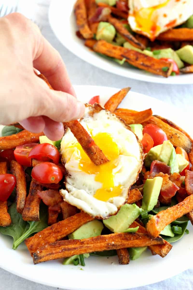 smothered breakfast sweet potato fries with avocado, bacon, tomatoes, eggs