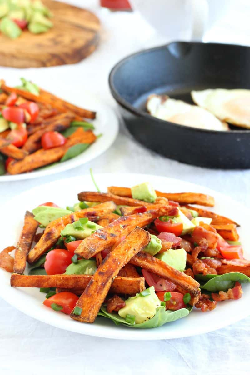 smothered paleo breakfast sweet potato fries with fried eggs