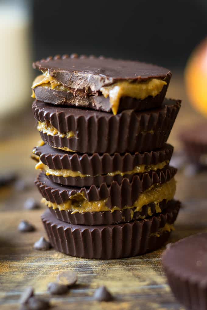pumpkin pie chocolate caramel cups stacked up on a board