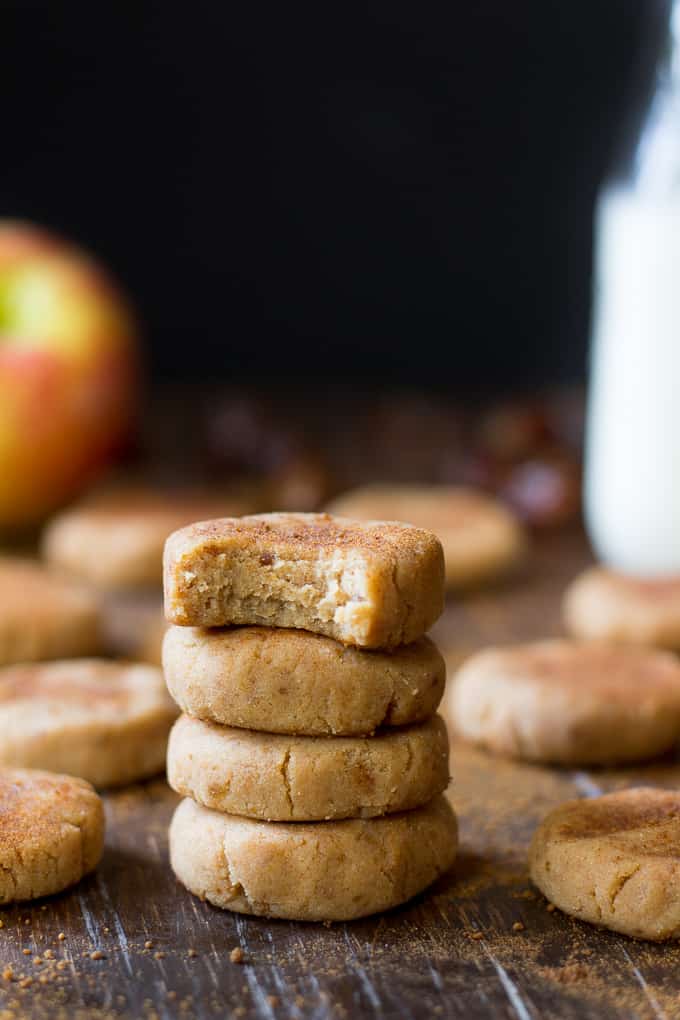 stack of no bake apple cinnamon cookies with scattered cookies in the background