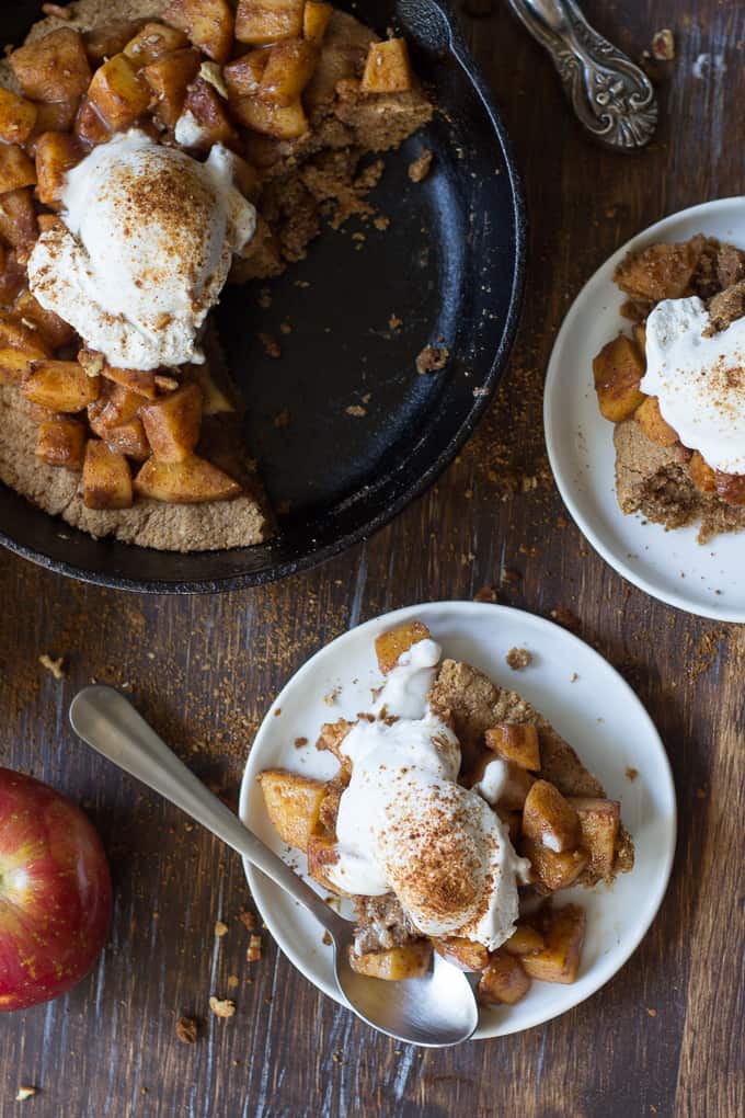 apple pie snickerdoodle skillet with two servings portioned on white plates