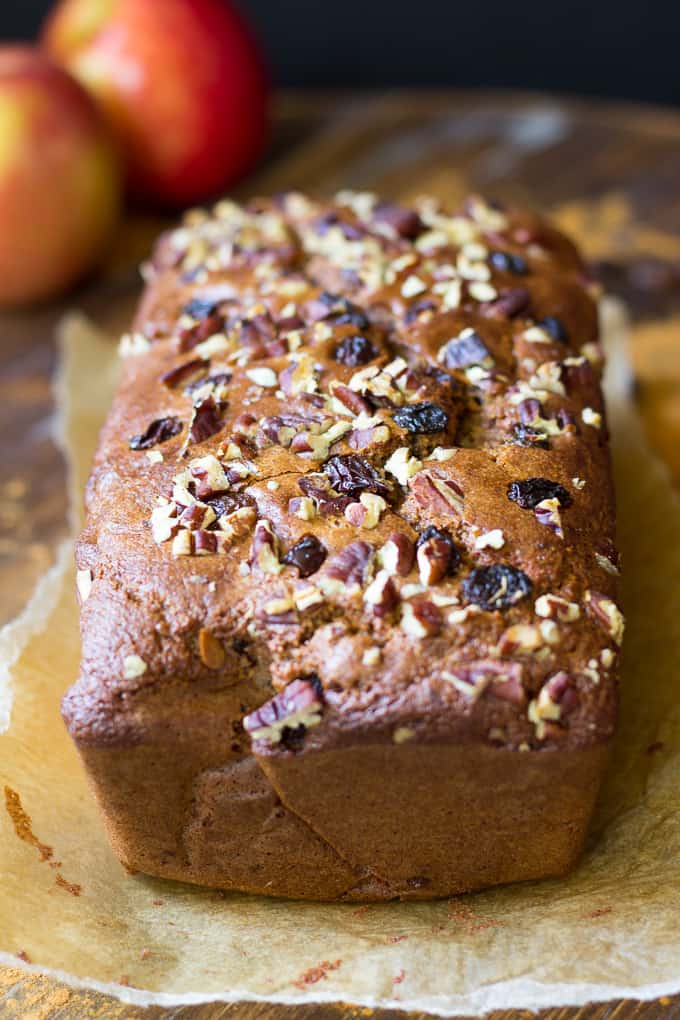 a loaf of paleo cinnamon raisin bread over parchment paper on a board