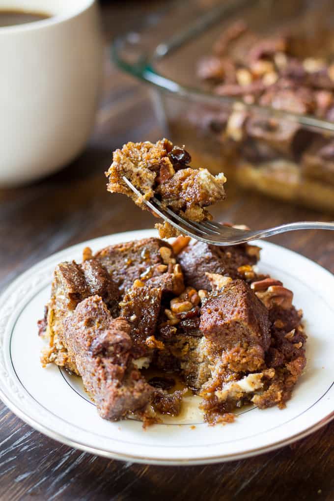 a bite of baked pumpkin french toast with pecans on a fork