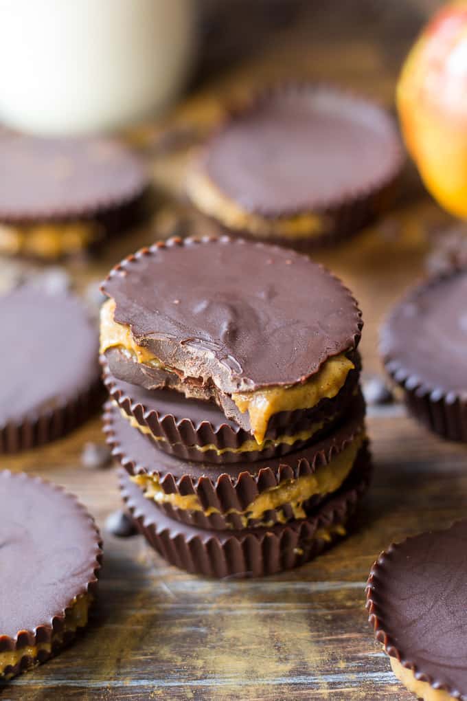 closeup shot of a stack of chocolate pumpkin pie caramel cups with a bite taken from the one on top