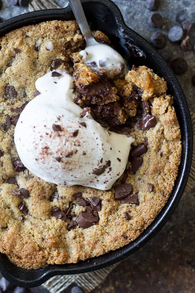 Paleo chocolate chip skillet cookies that are easy to make, rich and fudgy and packed with chocolate! Grain free, dairy free, gluten free, Paleo. Top with coconut ice cream for the ultimate Paleo dessert!