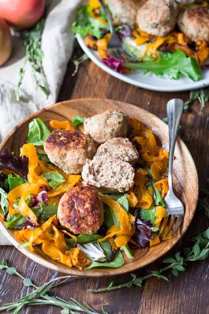 turkey meatballs and salad in a wooden bowl on a wooden board