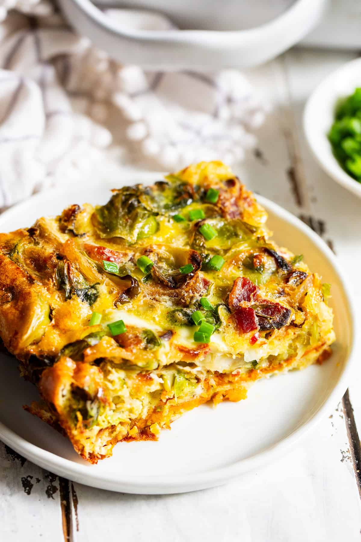Paleo breakfast casserole with bacon and sweet potatoes baked in a white casserole dish