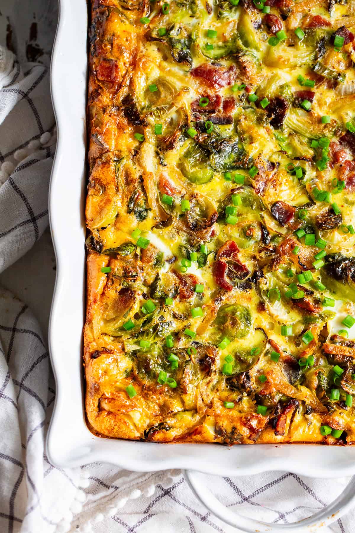 Paleo breakfast casserole with bacon and sweet potatoes baked in a white casserole dish