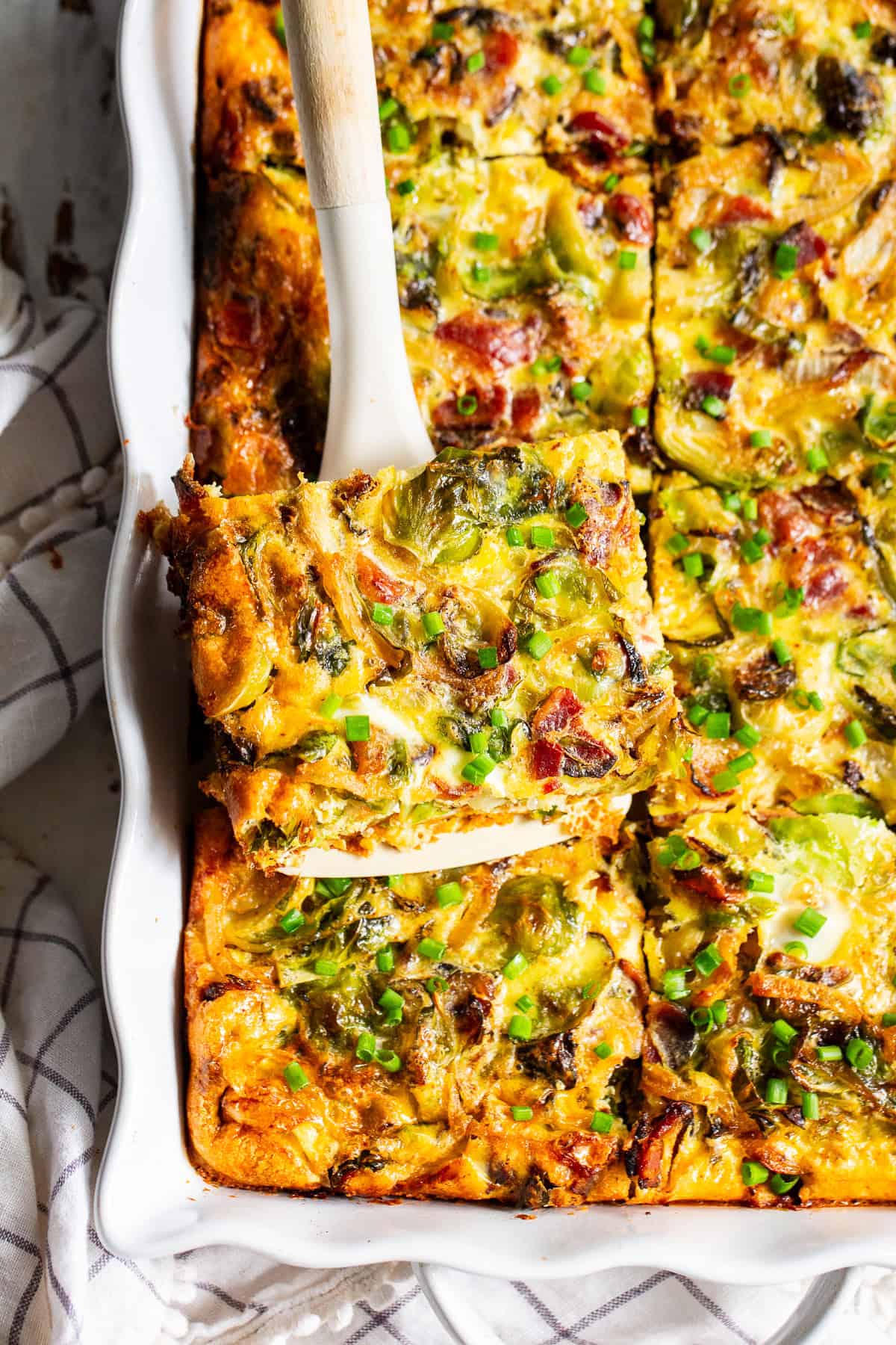 Paleo breakfast casserole with bacon and sweet potatoes baked in a white casserole dish