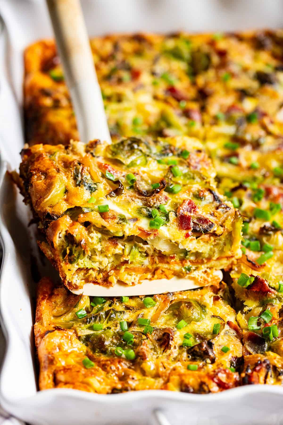 Paleo breakfast casserole with bacon and sweet potatoes baked in a white casserole dish