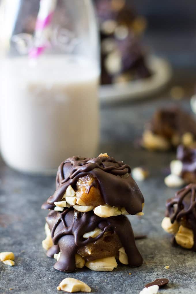 a stack of two chocolate covered caramel cashew clusters