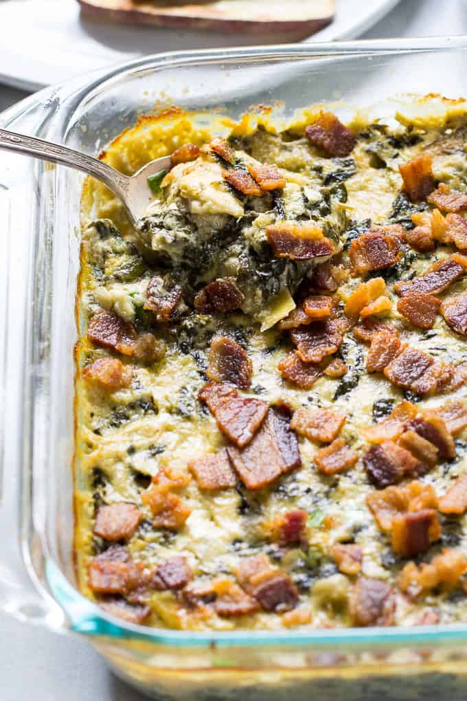 Creamy Baked Spinach Artichoke Dip that you won't believe is dairy free! Super creamy and packed with flavor, this dip is great for veggies, chips, and as a topping or spread for potatoes, chicken and burgers. Paleo & Whole30 compliant.