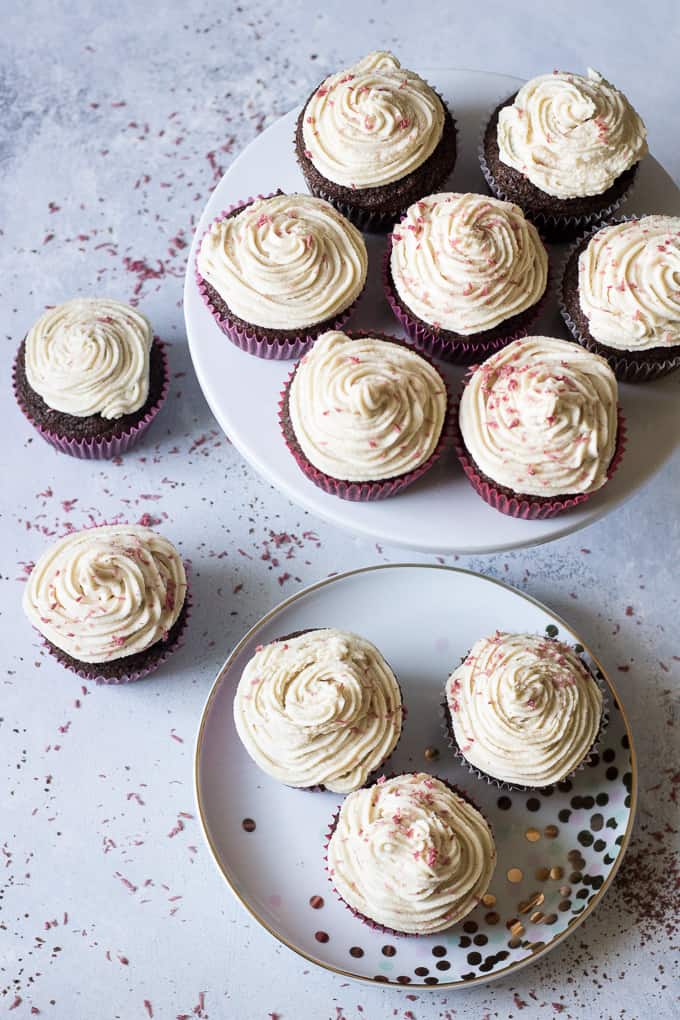 Perfect Paleo Chocolate Cupcakes (grain free, dairy free, soy free) made with coconut flour, topped with homemade coconut cashew "cream cheese" frosting and pink coconut sprinkles!