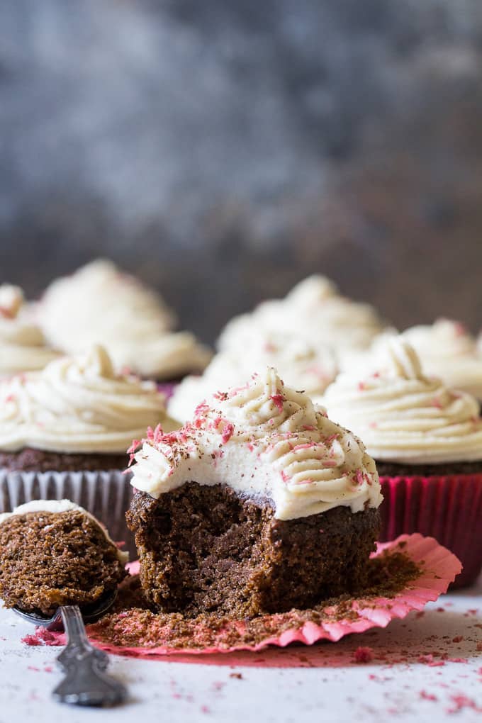 Perfect Paleo Chocolate Cupcakes (grain free, dairy free, soy free) made with coconut flour, topped with homemade coconut cashew "cream cheese" frosting and pink coconut sprinkles!