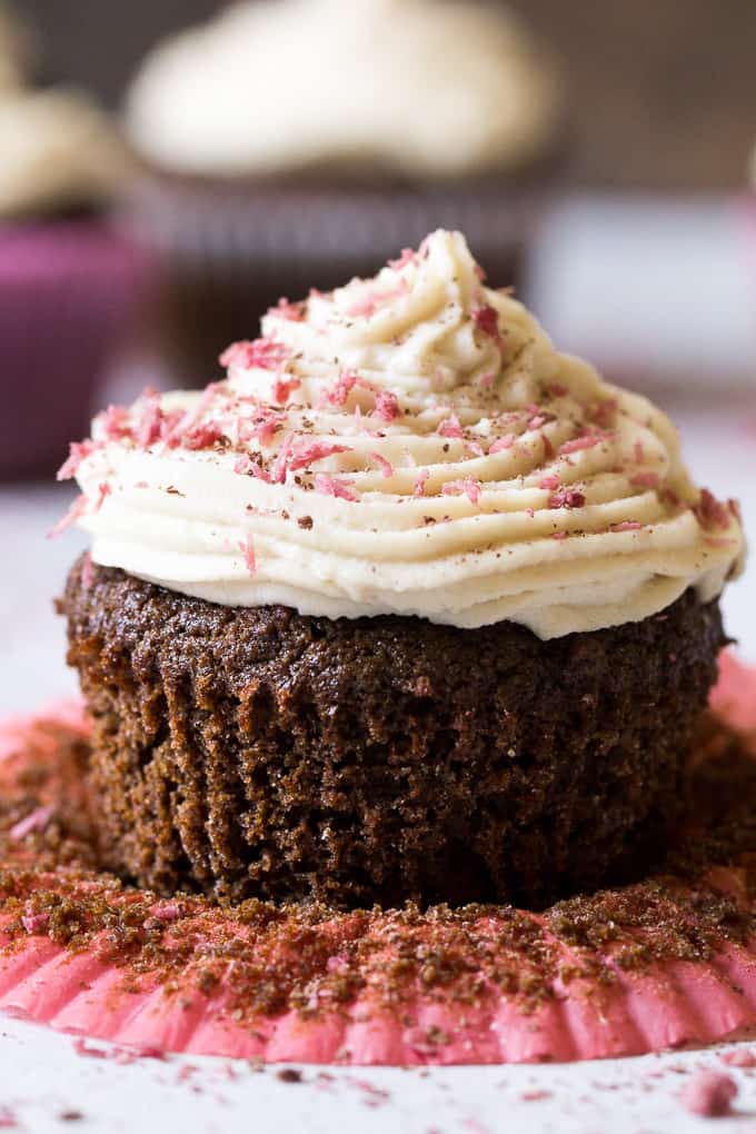 Perfect Paleo Chocolate Cupcakes (grain free, dairy free, soy free) made with coconut flour, topped with homemade coconut cashew "cream cheese" frosting and pink coconut sprinkles!