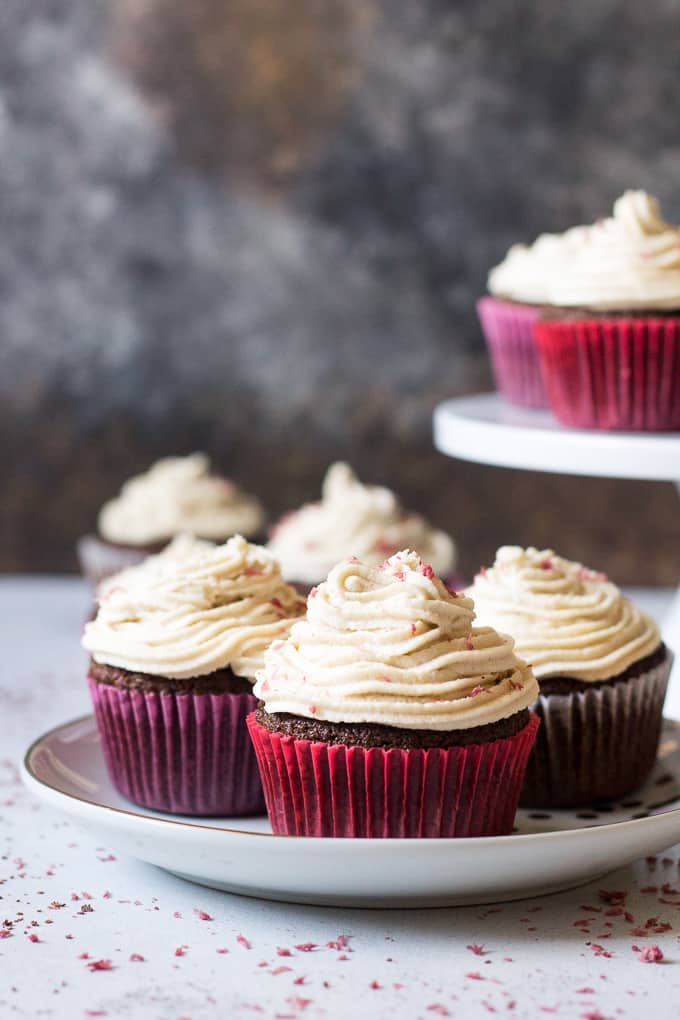 Perfect Paleo Chocolate Cupcakes (grain free, dairy free, soy free) made with coconut flour, topped with homemade coconut cashew "cream cheese" frosting and pink coconut sprinkles!