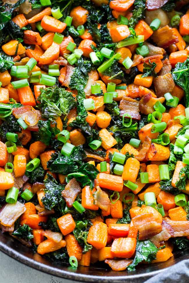 This savory roasted carrot, bacon and kale hash is great as a side dish or for breakfast topped with fried eggs! It's a lower carb alternative to the classic sweet potato hash and just as delicious. Paleo and Whole30 compliant, simple to make.