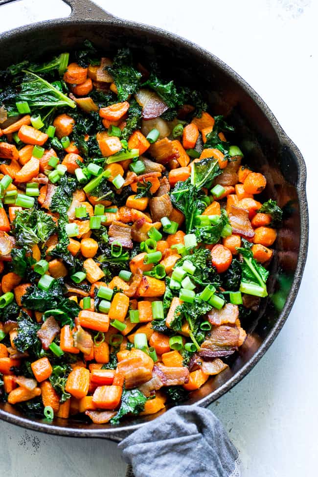 This savory roasted carrot, bacon and kale hash is great as a side dish or for breakfast topped with fried eggs! It's a lower carb alternative to the classic sweet potato hash and just as delicious. Paleo and Whole30 compliant, simple to make.