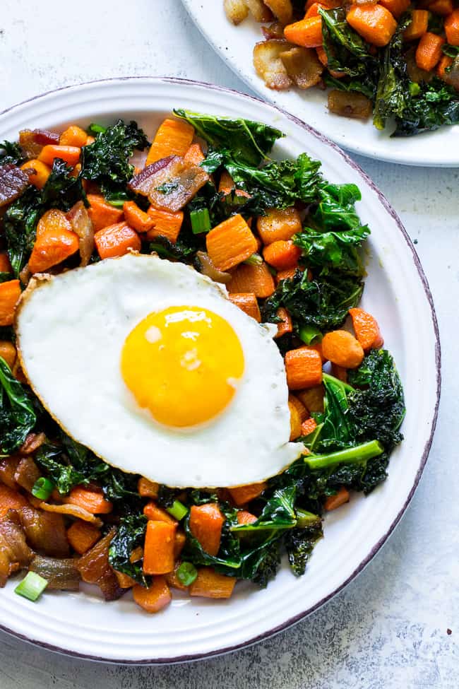 This savory roasted carrot, bacon and kale hash is great as a side dish or for breakfast topped with fried eggs! It's a lower carb alternative to the classic sweet potato hash and just as delicious. Paleo and Whole30 compliant, simple to make.