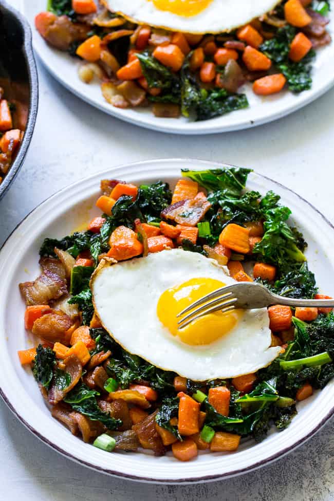 This savory roasted carrot, bacon and kale hash is great as a side dish or for breakfast topped with fried eggs! It's a lower carb alternative to the classic sweet potato hash and just as delicious. Paleo and Whole30 compliant, simple to make.