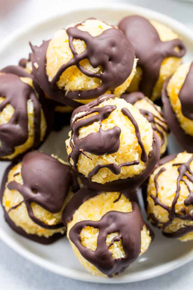Chewy and sweet orange coconut macaroons are dipped in dark chocolate for a healthy yet decadent tasting dessert! Easy and fun to make, these delicious macaroons are gluten free, dairy free and Paleo.
