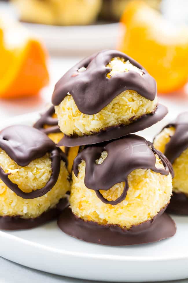 Chewy and sweet orange coconut macaroons are dipped in dark chocolate for a healthy yet decadent tasting dessert! Easy and fun to make, these delicious macaroons are gluten free, dairy free and Paleo.