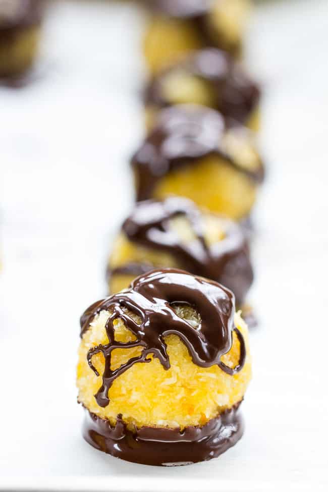 Chewy and sweet orange coconut macaroons are dipped in dark chocolate for a healthy yet decadent tasting dessert! Easy and fun to make, these delicious macaroons are gluten free, dairy free and Paleo.