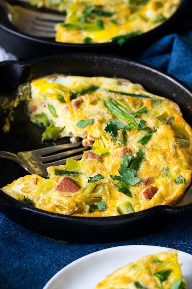 This easy, healthy asparagus frittata with spicy sausage and leeks is perfect for breakfast, brunch, or "brinnner" during the spring and summer months!  It's Paleo and Whole30 friendly, low carb, and ready in 30 minutes.  Perfect for breakfast, brunch, or breakfast for dinner!