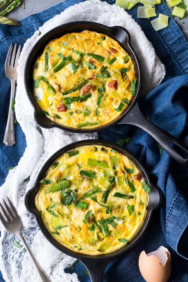 This easy, healthy asparagus frittata with spicy sausage and leeks is perfect for breakfast, brunch, or "brinnner" during the spring and summer months!  It's Paleo and Whole30 friendly, low carb, and ready in 30 minutes.  Perfect for breakfast, brunch, or breakfast for dinner!