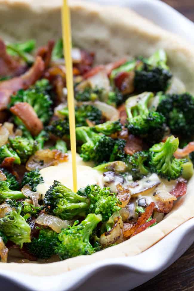 This Paleo broccoli quiche is easy to make and perfect as a make ahead breakfast or to bring to brunch for Easter, Mother's Day or anything else! It's loaded with caramelized onions, savory sautéed broccoli and crisp bacon, plus has a secret "cheesy" ingredient while remaining dairy free! Grain free, gluten free, healthy.