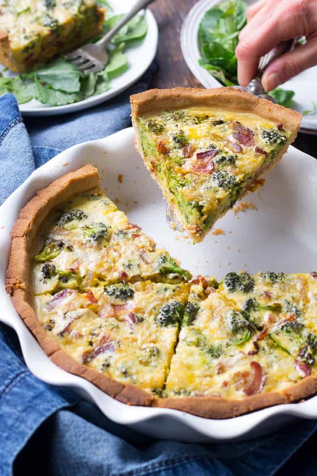 This Paleo broccoli quiche is easy to make and perfect as a make ahead breakfast or to bring to brunch for Easter, Mother's Day or anything else! It's loaded with caramelized onions, savory sautéed broccoli and crisp bacon, plus has a secret "cheesy" ingredient while remaining dairy free! Grain free, gluten free, healthy.