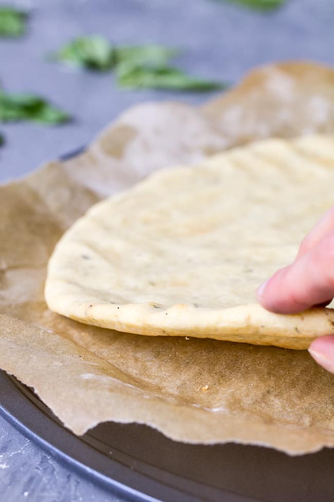 This quick and easy paleo pizza crust will be your new go-to whenever a pizza craving strikes! The ingredients mix together in one bowl and it's ready in under 30 minutes. Top it however you like for any meal! Kid friendly, gluten free, grain free, dairy free.