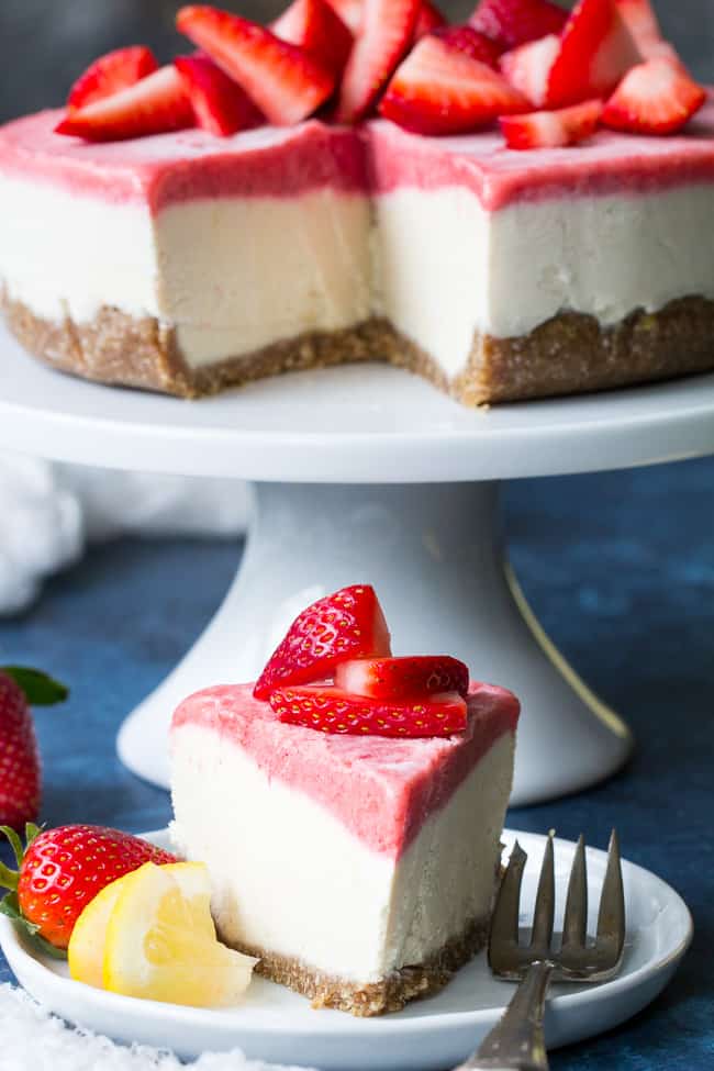 This no-bake Paleo and vegan cheesecake has a chewy, naturally sweet crust, topped with a thick creamy lemon layer and a sweet creamy strawberry layer. The cheesecake layers have a cashew base, come together quickly in a blender or food processor, and are then chilled to set. Gluten free, dairy free, refined sugar free.