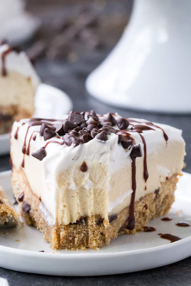 This chocolate chip cookie vanilla cheesecake starts with a thick chewy chocolate chip cookie layer topped with creamy cashew vanilla cheesecake, coconut whipped cream, more chocolate chips and a rich chocolate drizzle.  It’s the perfect secretly healthy dessert for any special occasion!  Gluten free, dairy free, paleo and vegan.