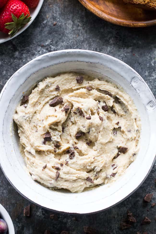 This super quick and easy cashew-based chocolate chip cheesecake dip (or spread!) is perfect for healthy sweet snacks and desserts. No need to make a whole cheesecake when a craving hits! This versatile dip/spread is dairy-free, paleo, vegan, and loaded with creamy texture and dark chocolate.
