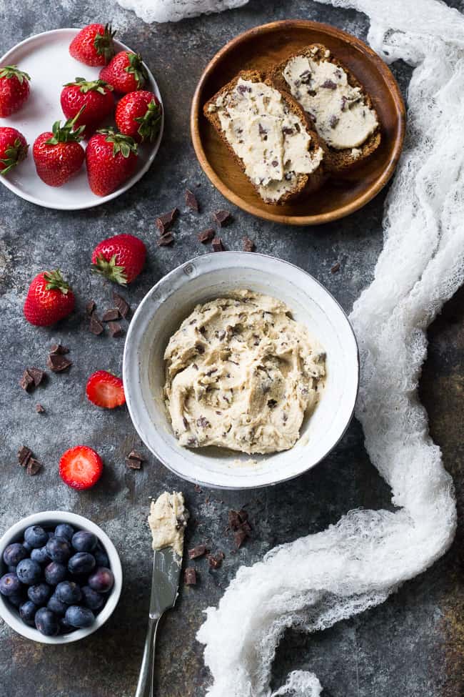 This super quick and easy cashew-based chocolate chip cheesecake dip (or spread!) is perfect for healthy sweet snacks and desserts. No need to make a whole cheesecake when a craving hits! This versatile dip/spread is dairy-free, paleo, vegan, and loaded with creamy texture and dark chocolate.