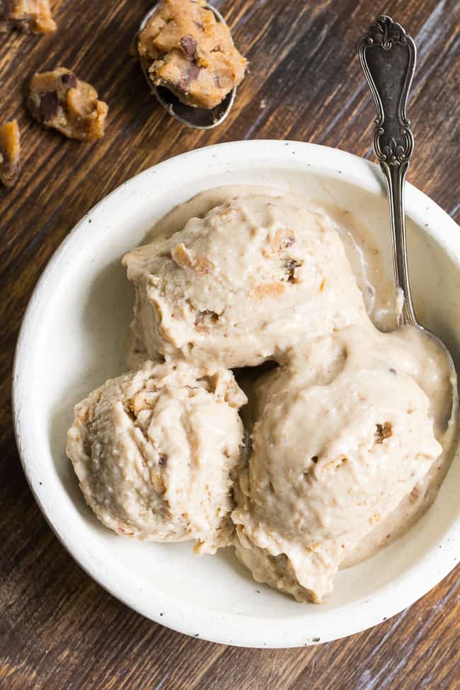 This no-churn chocolate chip cookie dough paleo & vegan ice cream is creamy and loaded with chewy cookie dough bites, yet secretly so healthy!  The ice cream base is sweetened with dates and bananas and comes together quickly in a blender.  The cookie dough takes two minutes to make and is grain free and dairy free.   It's a healthy and addicting frozen treat that you'll want to make again and again!