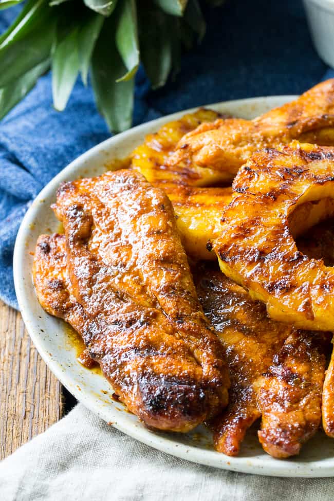 This Paleo pineapple chicken has a sweet pineapple glaze with a Whole30 friendly option too! It's easy, healthy, kid approved and perfect for summer grilling. It can also be made stovetop in a grill-pan. Refined sugar, free gluten-free and dairy-free.