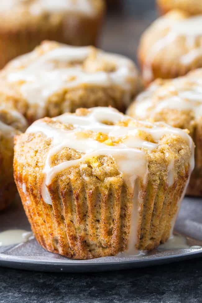 Moist and fluffy pineapple banana muffins with a coconut pineapple drizzle that tastes like a pina colada! You won't believe these tropical muffins are actually paleo, gluten-free, dairy-free and healthy! Great for breakfast or a snack and kid approved too!