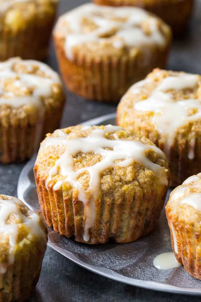 Moist and fluffy pineapple banana muffins with a coconut pineapple drizzle that tastes like a pina colada! You won't believe these tropical muffins are actually paleo, gluten-free, dairy-free and healthy! Great for breakfast or a snack and kid approved too!