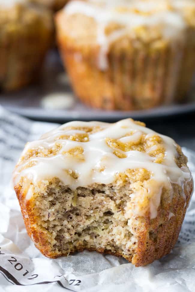 Moist and fluffy pineapple banana muffins with a coconut pineapple drizzle that tastes like a pina colada! You won't believe these tropical muffins are actually paleo, gluten-free, dairy-free and healthy! Great for breakfast or a snack and kid approved too!