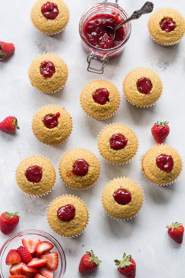 These Strawberry Shortcake Cupcakes start with a perfect paleo vanilla cupcake, filled with honey sweetened strawberry preserves and topped with thick and creamy coconut whipped cream. They're gluten free, dairy free, kid approved, fun to make, and perfect for any special occasion or holiday!